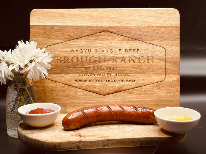 Brough Ranch delicious beef chorizo on a cutting board next to ketchup and mustard ￼ 
